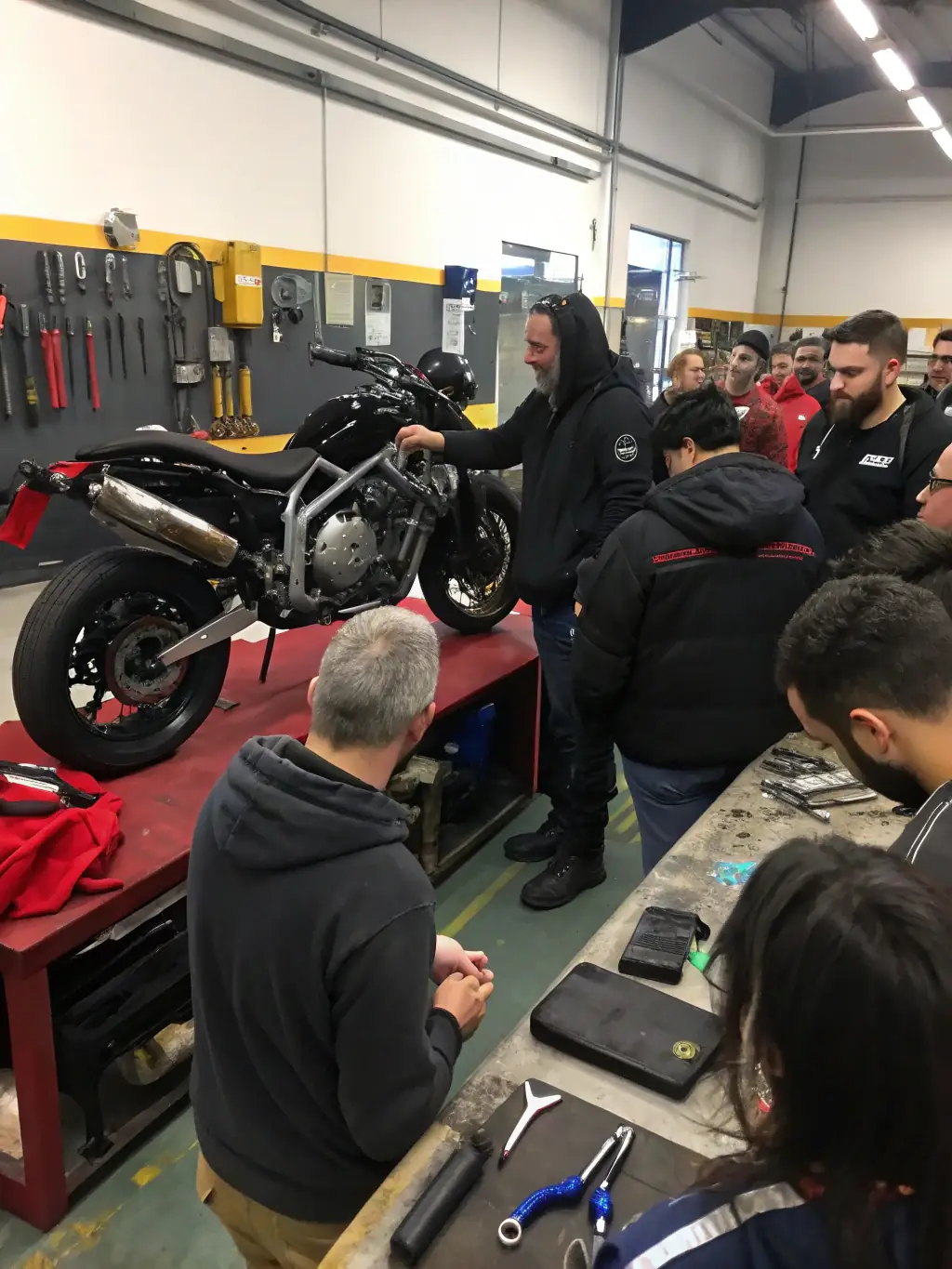 Nantouillet Motorcycle Club members participating in a motorcycle safety workshop, demonstrating proper riding techniques and maintenance tips.
