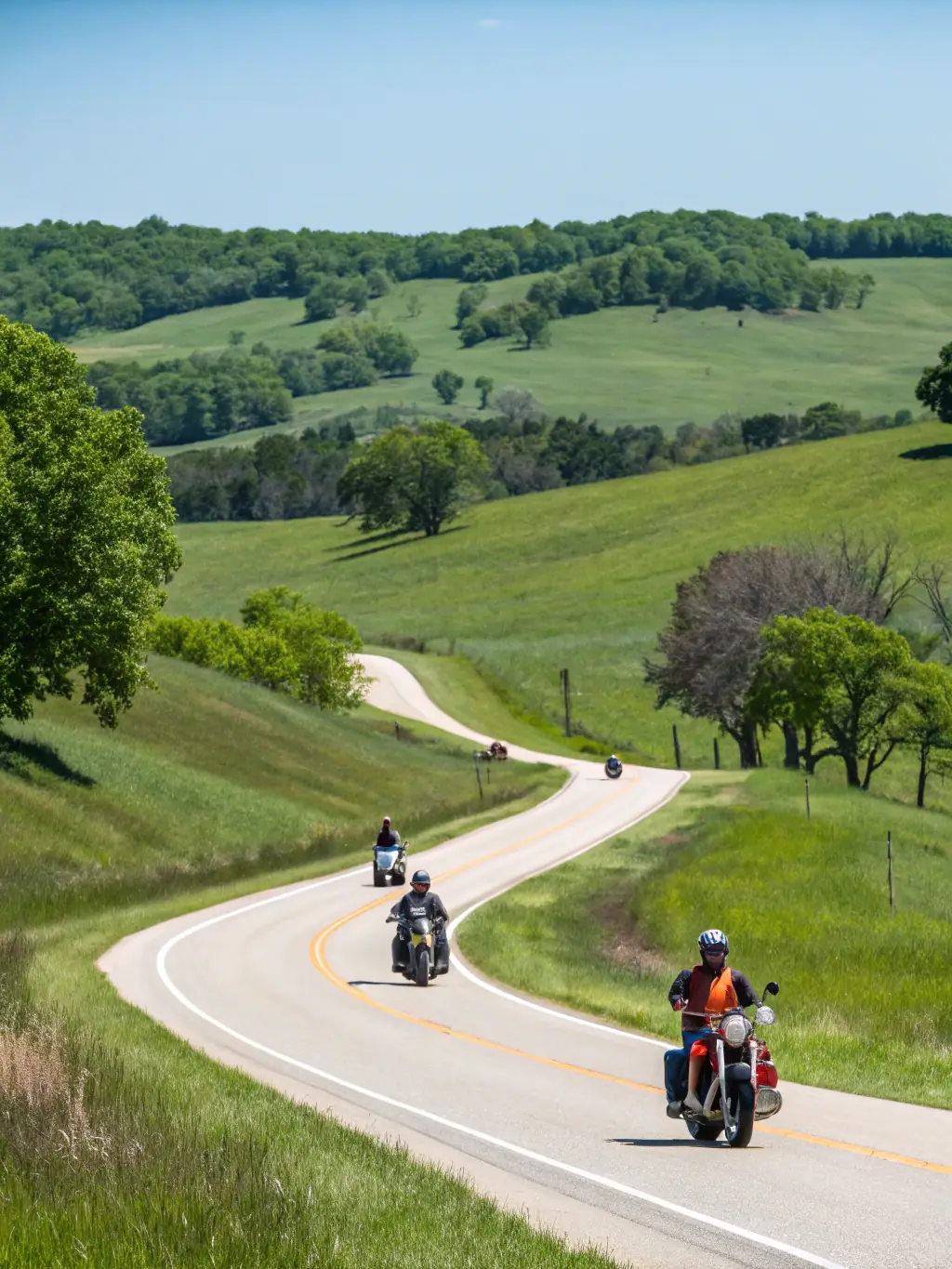 A group of Nantouillet Motorcycle Club members riding their motorcycles on a scenic country road during a club-organized event, showcasing the adventure and camaraderie.